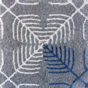 Sine wool rug in shades of grey, blue, and white, combining traditional and modern patterns.