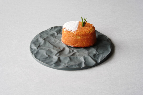 Round grey porcelain serving tray Arid with crumpled paper texture